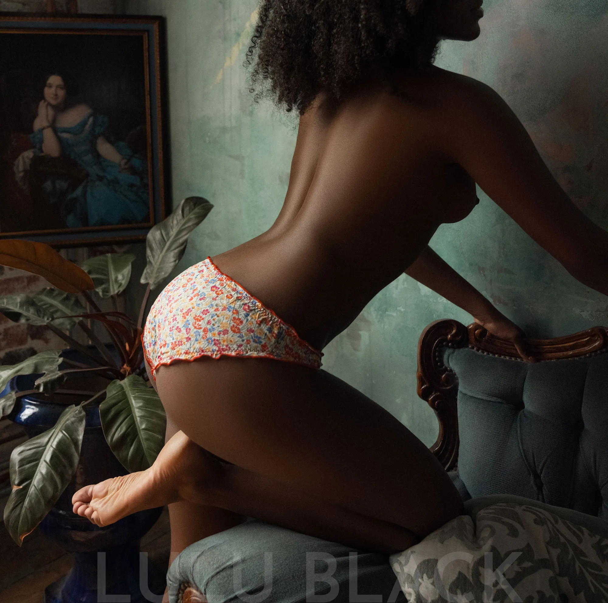 Bottoms up! Naomi looking cute in flowery knickers, showing off her smooth ebony skin tone.